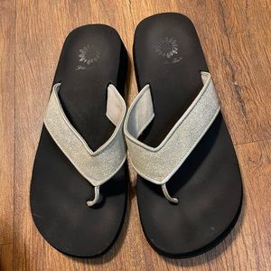 Yellow Box flip flops.  Black sole with silver glittery straps.  Size: 10